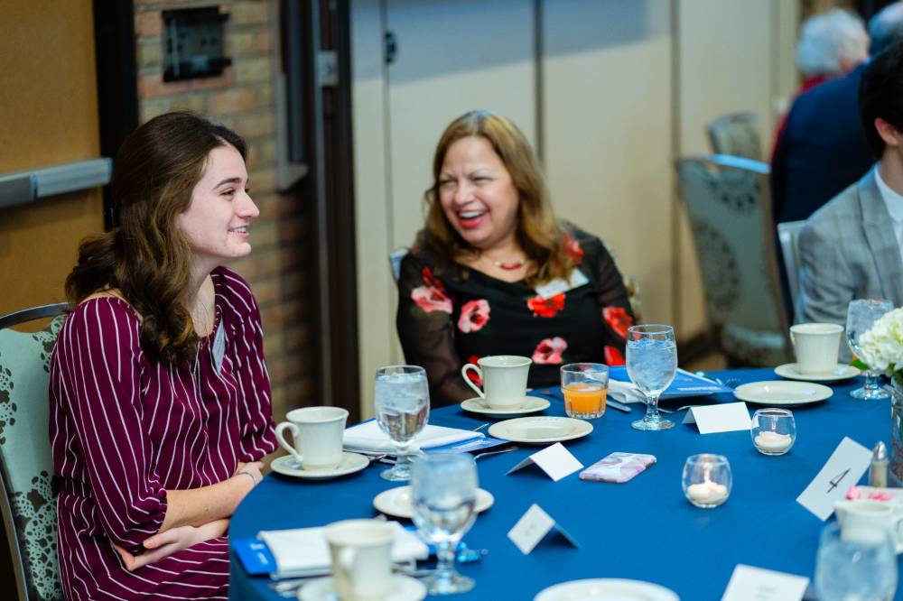 Student and donor sitting at a table at Scholarship Dinner 2019